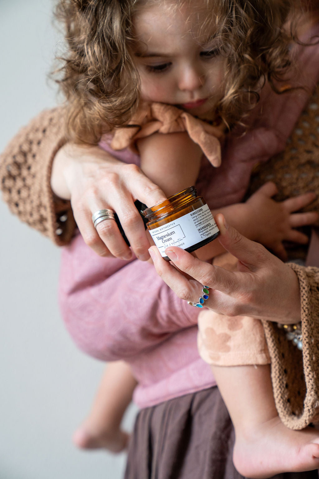 Organic botanical magnesium cream being applied to baby